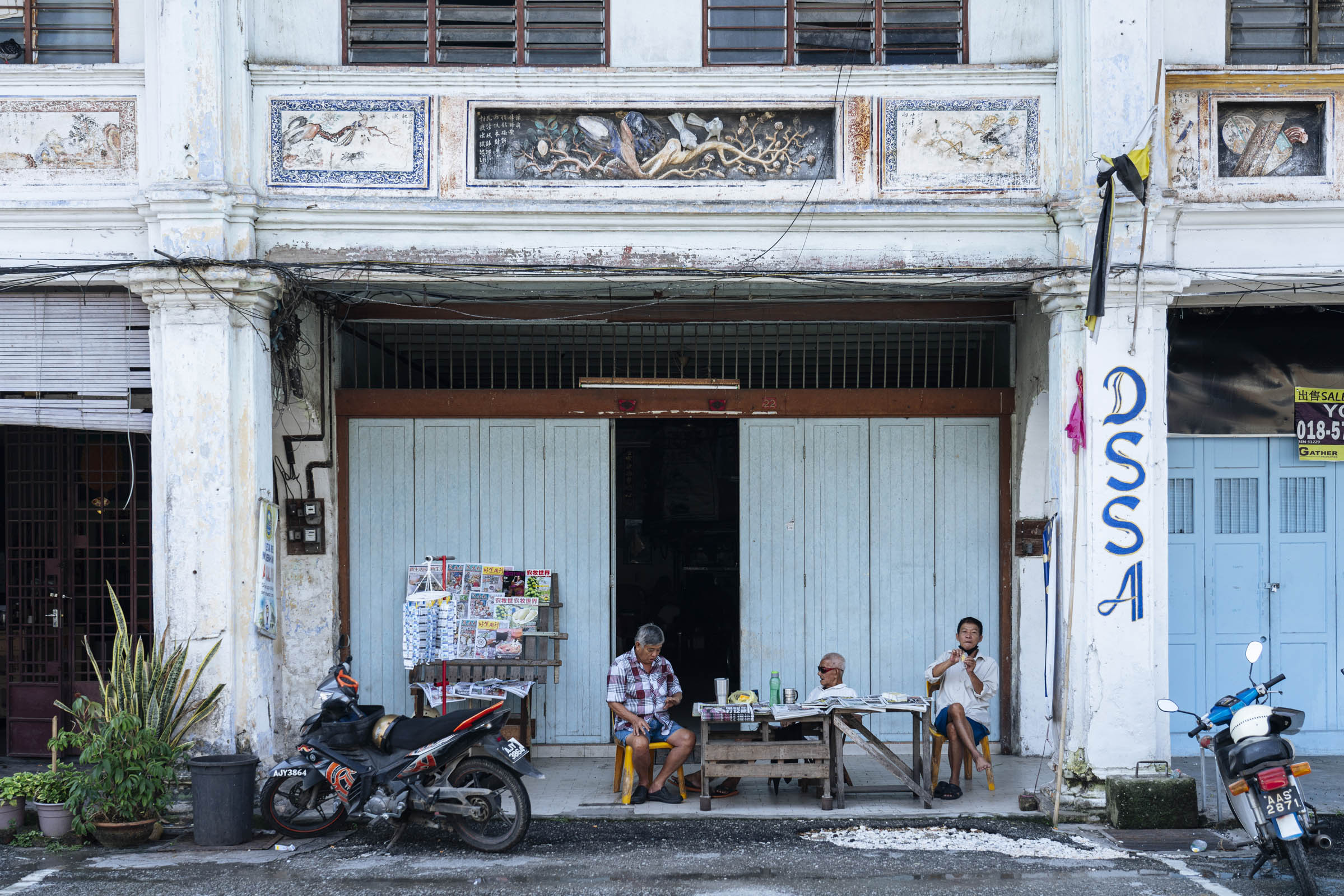 Locals hanging out at the newspaper stall in Gopeng town centre. Photo by Teoh Eng Hooi.